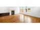 Bright living area featuring hardwood floors, a fireplace, and access to the backyard at 1934 S Sherman St, Denver, CO 80210