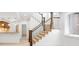 Living area with stairs featuring wood and metal banisters with large windows at 1934 S Sherman St, Denver, CO 80210