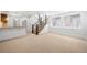 Open-concept living area with stairs and natural light from the windows at 1934 S Sherman St, Denver, CO 80210