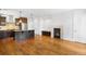 Open living area with hardwood floors, fireplace, and kitchen island at 1934 S Sherman St, Denver, CO 80210