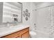 Bright bathroom with a large mirror and shower-tub combo at 10525 Akron St, Commerce City, CO 80640