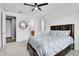 Bright bedroom featuring a ceiling fan, and a comfortable bed, with a view to the bathroom at 10525 Akron St, Commerce City, CO 80640