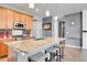 Well-lit kitchen featuring a large island with barstool seating and modern appliances at 10525 Akron St, Commerce City, CO 80640