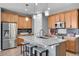 Stylish kitchen featuring granite countertops, a center island with seating, and ample cabinet space at 10525 Akron St, Commerce City, CO 80640