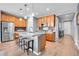 Modern kitchen with granite countertops, a center island with seating, and stainless steel appliances at 10525 Akron St, Commerce City, CO 80640