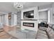 Inviting living room with a modern fireplace, TV, and sleek glass coffee table at 10525 Akron St, Commerce City, CO 80640