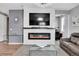 Modern living room with a fireplace, mounted TV, and comfortable leather seating at 10525 Akron St, Commerce City, CO 80640