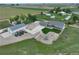 Stunning aerial view of a farmhouse with spacious garage and recreational area at 6331 County Road 32, Platteville, CO 80651