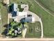 A bird's-eye view of the property, showcasing the house, outbuildings, and surrounding land at 6331 County Road 32, Platteville, CO 80651