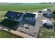 Expansive aerial view of a home with large buildings, a garden, and vast fields at 6331 County Road 32, Platteville, CO 80651