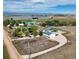 A high aerial view of the home, buildings and countryside conveys a sense of seclusion at 6331 County Road 32, Platteville, CO 80651