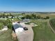 Scenic view of the property featuring the main house, outbuildings, green fields, and distant mountains at 6331 County Road 32, Platteville, CO 80651