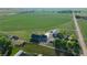 A high-angle view of the house and outbuilding, set against a backdrop of green fields at 6331 County Road 32, Platteville, CO 80651