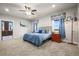 Comfortable bedroom featuring soft carpet, a plush bed, and side tables with lamps at 6331 County Road 32, Platteville, CO 80651