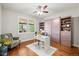 Cozy bedroom with stylish murphy bed, hardwood floors, and natural light at 6331 County Road 32, Platteville, CO 80651