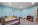Cheerful ' bedroom with custom-built bed frame, playful decor, and comfortable carpeting at 6331 County Road 32, Platteville, CO 80651