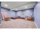 Comfortable carpeted bedroom featuring a cozy bed, a small table and chairs, and a charming map decoration at 6331 County Road 32, Platteville, CO 80651