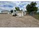 Rustic chicken coop with fenced enclosure, surrounded by gravel, ideal for raising poultry at 6331 County Road 32, Platteville, CO 80651