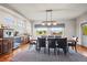 Bright dining room featuring hardwood floors, a wooden table with leather chairs, and scenic views at 6331 County Road 32, Platteville, CO 80651