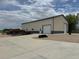 A large, modern outbuilding or garage is set off by a new concrete apron at 6331 County Road 32, Platteville, CO 80651