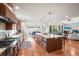 Spacious open-concept kitchen with modern appliances, granite counters, a large island, and hardwood floors at 6331 County Road 32, Platteville, CO 80651