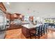 An open kitchen features granite counters, stainless appliances, and hardwood flooring at 6331 County Road 32, Platteville, CO 80651