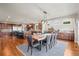 Expansive kitchen with dining area, featuring hardwood floors, modern appliances and breakfast bar seating at 6331 County Road 32, Platteville, CO 80651