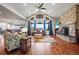 Vaulted ceiling, stone fireplace, and a wall of windows are highlights of this living room at 6331 County Road 32, Platteville, CO 80651