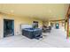 Relaxing covered outdoor patio with a hot tub, dining set, recessed lighting, and access to the home and yard at 6331 County Road 32, Platteville, CO 80651