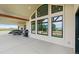 Large covered patio with windows, a grill, and dining furniture, ideal for outdoor entertaining at 6331 County Road 32, Platteville, CO 80651