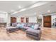 Spacious rec room with plush seating, wood-look floors, and plenty of room for activities at 6331 County Road 32, Platteville, CO 80651