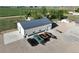 Exterior shot of a large shop with concrete parking pad and gravel drive at 6331 County Road 32, Platteville, CO 80651