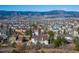 A neighborhood with mountain views and a house with a brown roof and a well-maintained lawn at 15653 Split Creek Dr, Monument, CO 80132