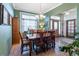 Bright dining room featuring tile floors, green walls, and natural light, great for entertaining guests at 15653 Split Creek Dr, Monument, CO 80132