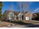 Charming home with a well-maintained lawn, mature trees, and a two-car garage at 15653 Split Creek Dr, Monument, CO 80132