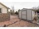 Backyard shed with a fence and rock landscaping for extra storage and privacy at 15653 Split Creek Dr, Monument, CO 80132