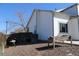 Backyard area with gravel, wooden planter, grill, and fencing at 12135 Elizabeth St, Thornton, CO 80241