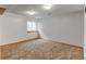 A finished basement space with a window for natural light and carpet at 12135 Elizabeth St, Thornton, CO 80241