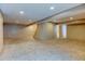 A finished basement with carpet, neutral walls, and recessed lighting at 12135 Elizabeth St, Thornton, CO 80241