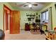 Bright bedroom with a workspace featuring a desk, ceiling fan, and window at 12135 Elizabeth St, Thornton, CO 80241
