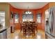 A dining area with a wooden table set, hardwood floors, and lots of natural light at 12135 Elizabeth St, Thornton, CO 80241