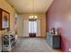 Dining room with chandelier, curtains, artwork, and console table at 12135 Elizabeth St, Thornton, CO 80241