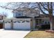 Two-story home with a three-car garage, brick accents, and a cozy front porch at 12135 Elizabeth St, Thornton, CO 80241