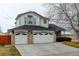 Charming two-story home featuring a three-car garage and traditional architectural details at 12135 Elizabeth St, Thornton, CO 80241