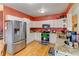 Cozy kitchen boasts stainless steel appliances, granite countertops, and a vibrant accent wall at 12135 Elizabeth St, Thornton, CO 80241