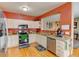 Kitchen with stainless steel appliances, granite counters, and opening to the dining area at 12135 Elizabeth St, Thornton, CO 80241