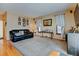 Spacious living room featuring a comfortable sofa, large windows, and ample seating at 12135 Elizabeth St, Thornton, CO 80241