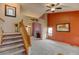 Spacious living room with carpet flooring, stairs, and a vaulted ceiling at 12135 Elizabeth St, Thornton, CO 80241