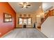 Inviting living room featuring a ceiling fan, windows, and carpet flooring at 12135 Elizabeth St, Thornton, CO 80241