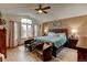 Comfortable main bedroom featuring a large bed, seating area, and bright windows at 12135 Elizabeth St, Thornton, CO 80241